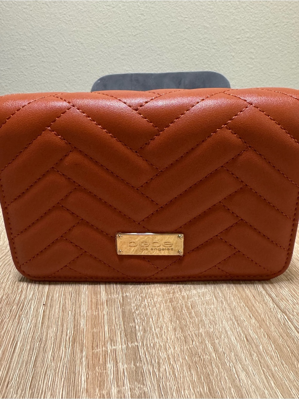 bebe Quilted Orange Crossbody with Gold Plaque Accent